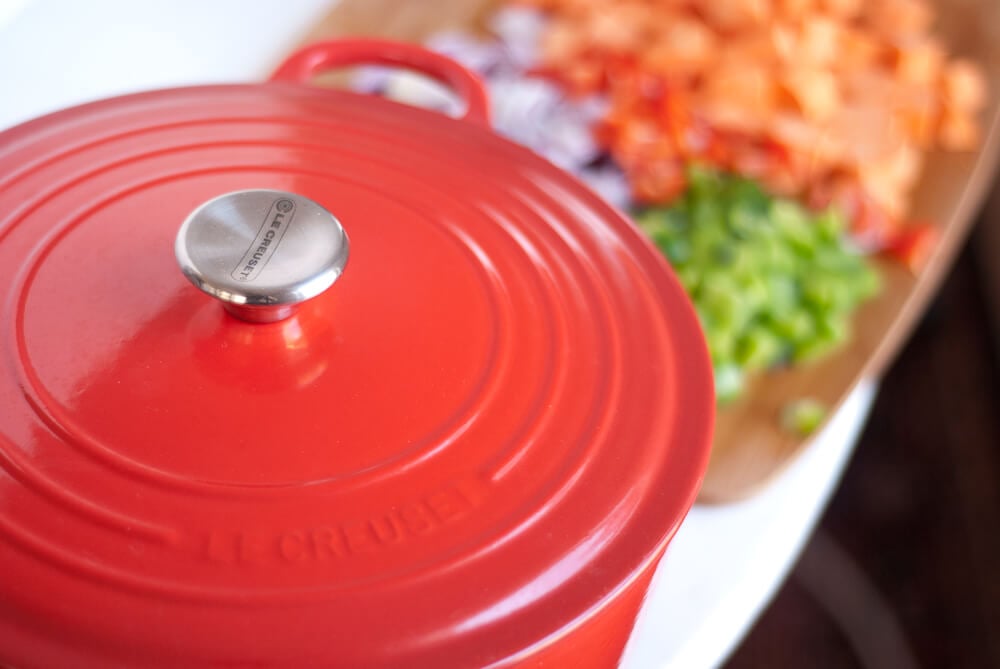 Red Le Creuset French oven and chili ingredients Red Le Creuset French oven and chili ingredients