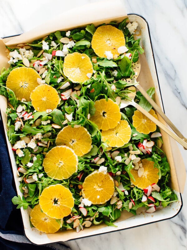 orange arugula salad with goat cheese, almonds and radishes