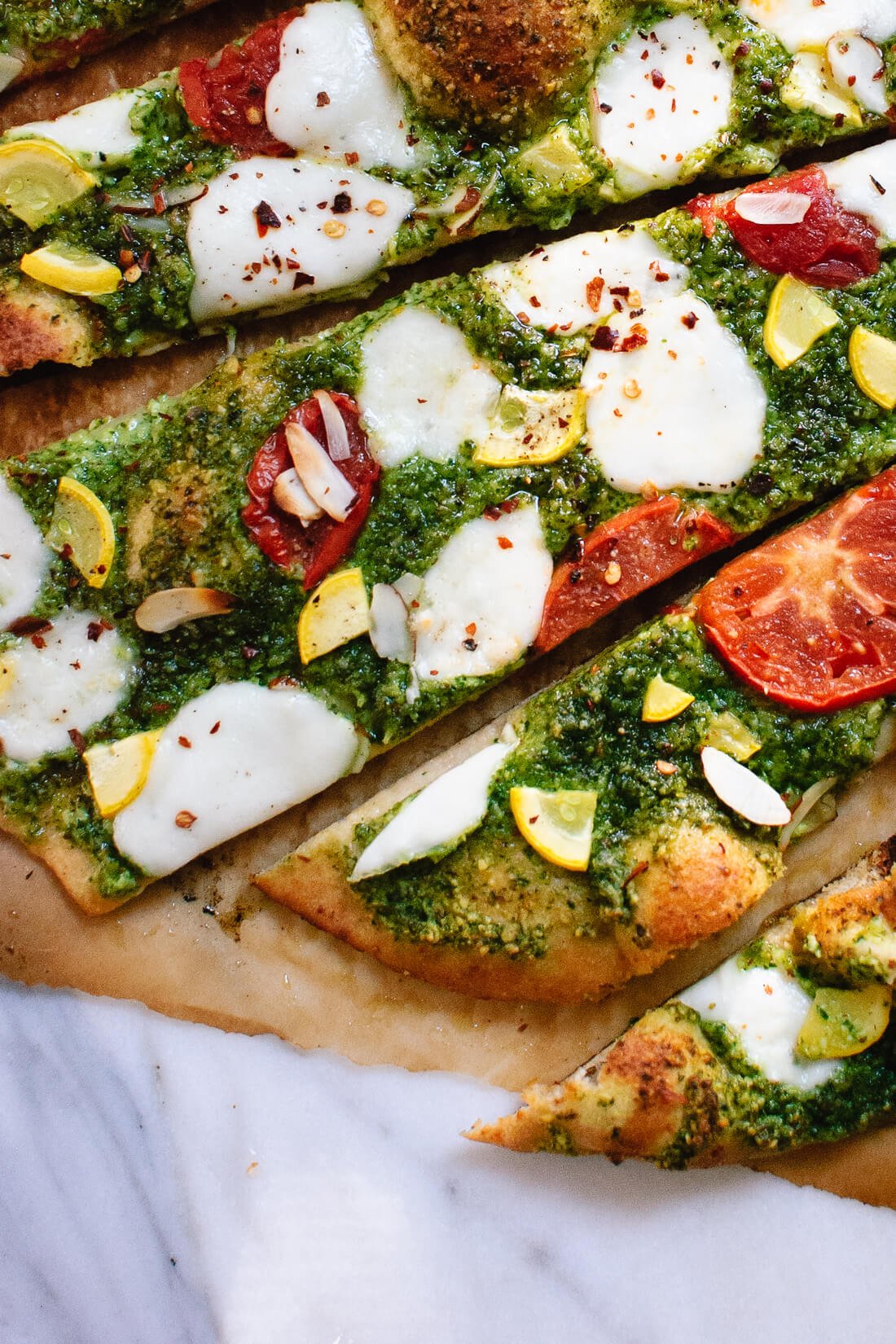 Homemade arugula-almond pesto pizza with a simple whole wheat crust