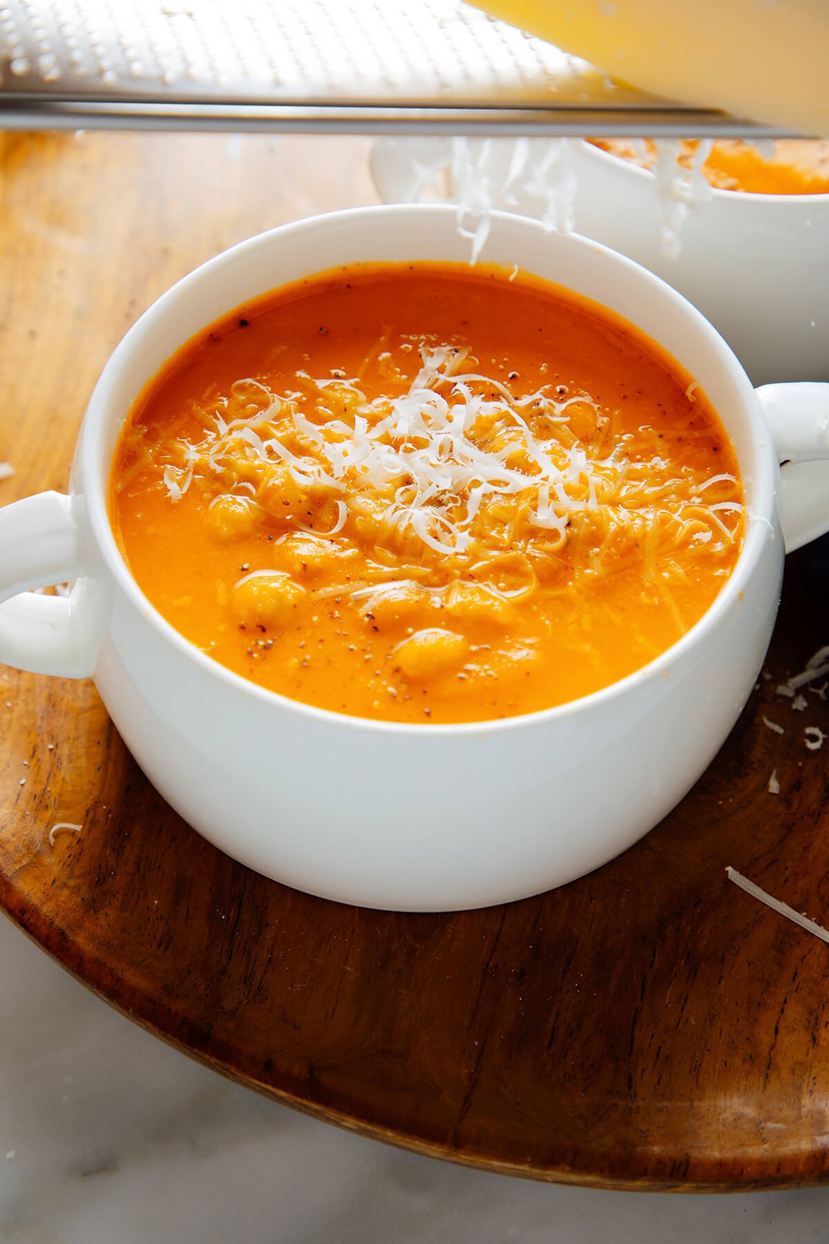 grating parmesan into soup
