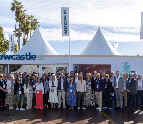 Image of large Newcastle delegation in front of the Newcastle pavilion in Cannes.