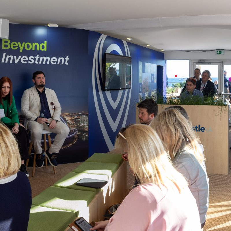 Panoramic image of the interior of the Newcastle stand at MIPIM whilst a presentation is taking place.