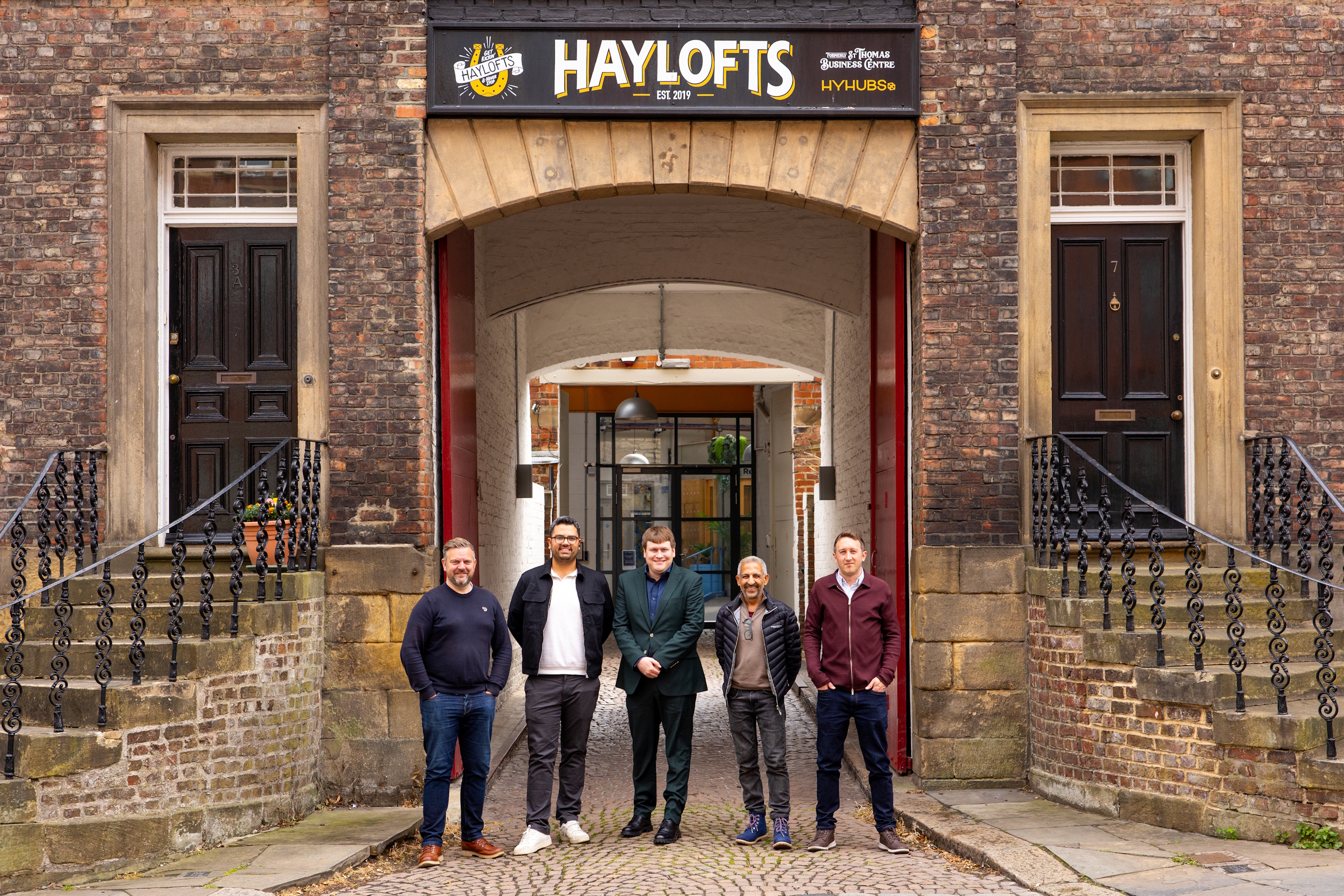 Team from AMA and Newcastle Council Deputy Leader stood outside of the Haylofts office building.